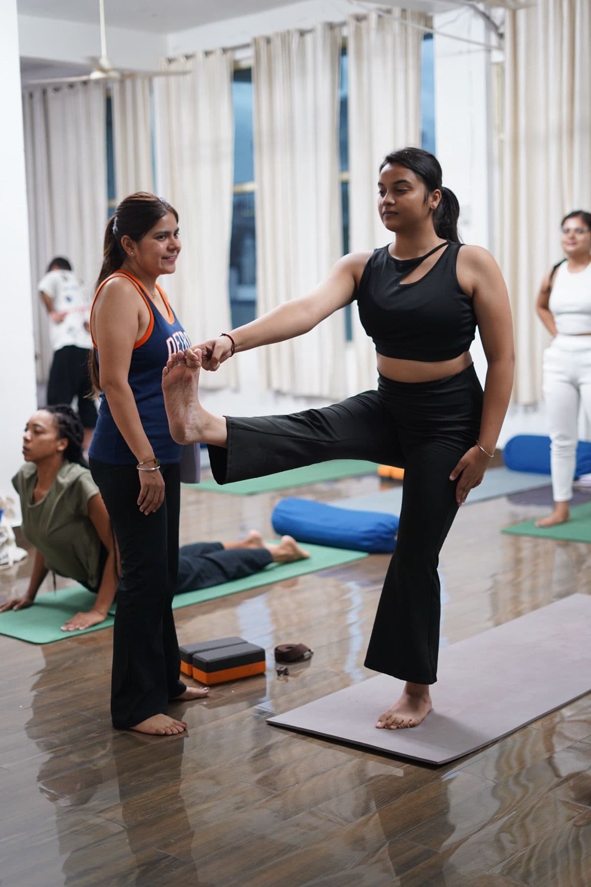 Shilpa giving a hands-on adjustment in a private session