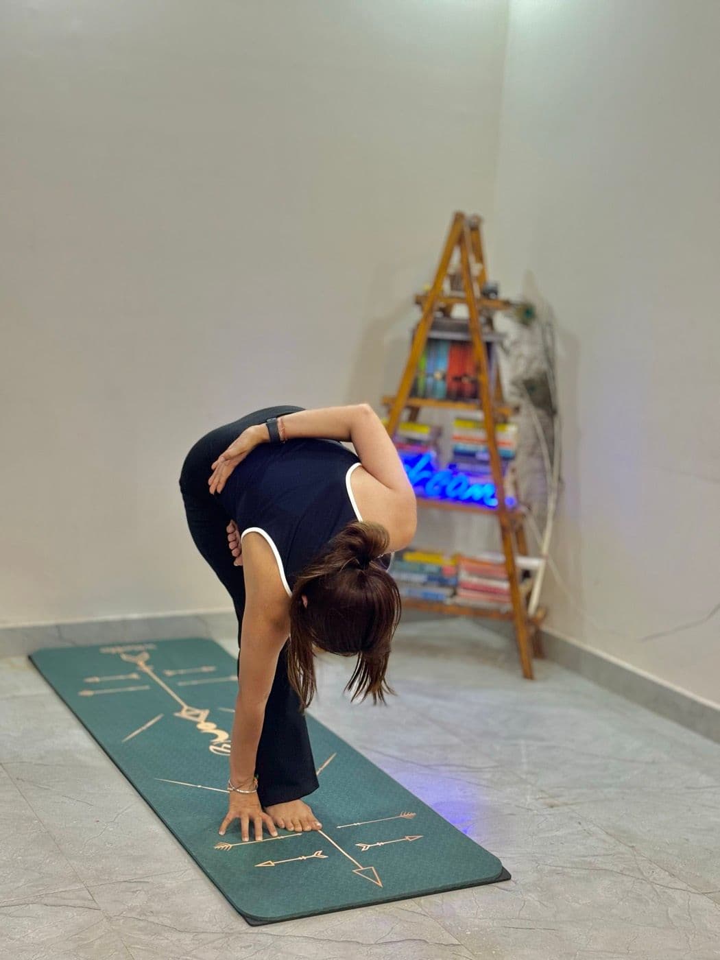 Shilpa folding forward in her studio